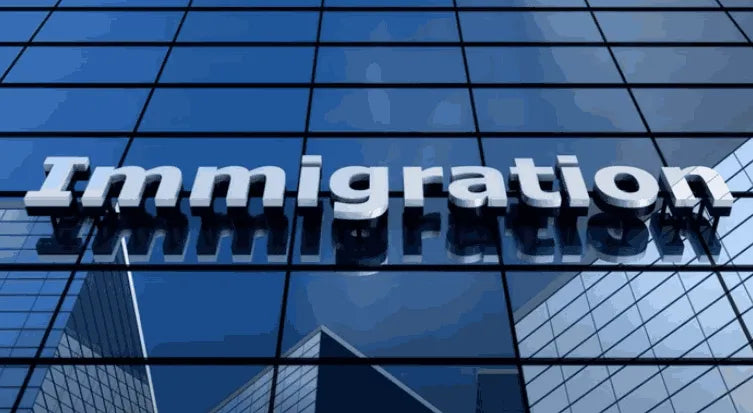 Glass building with 'Immigration' sign on a blue grid background